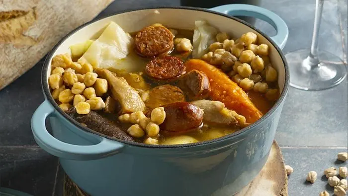 Authentic Cocido Madrileño served in a traditional clay pot - Madrid Food Tours