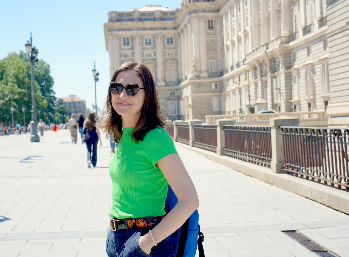 Amanda Buttinger, a Madrid-based travel guide, walking along the Royal Palace promenade in Spain